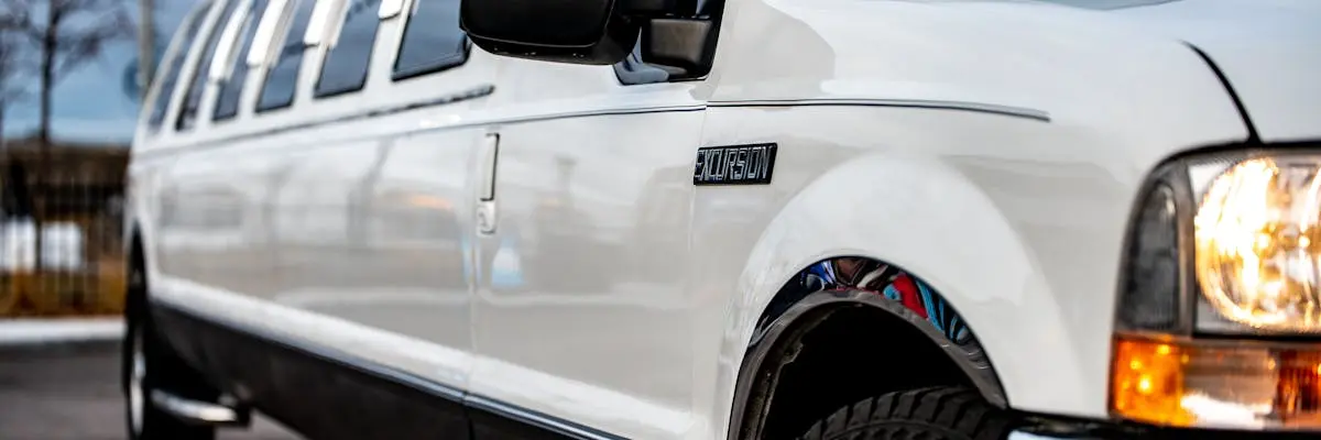 White stretch limousine alongside the curb